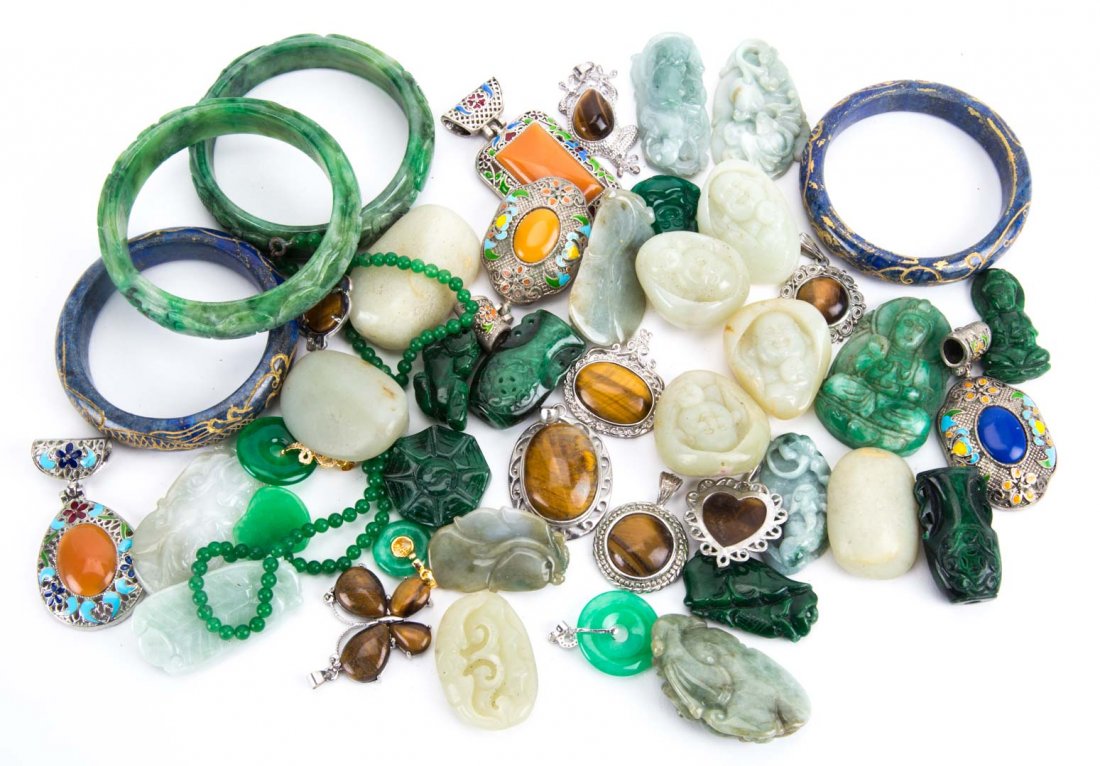 A Collection of Jade Jewelry and Scholar Pieces: Multi colored jade along with tiger's eye and Tibetan pendants