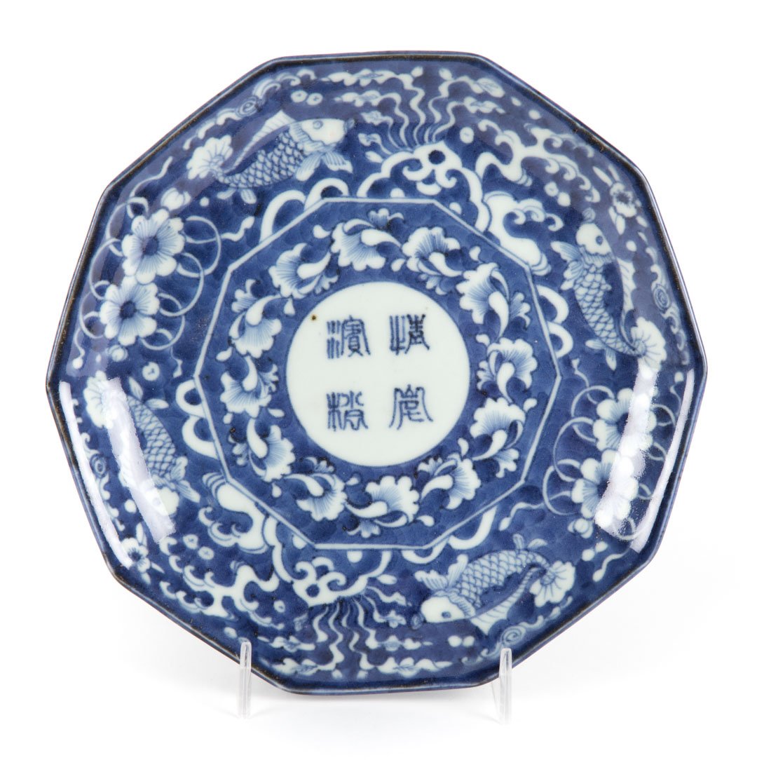 Japanese Arita porcelain octagonal dish: late 18th century; with stylized carp, floral, and character decoration, underglaze blue mark, 8 in. Diam.