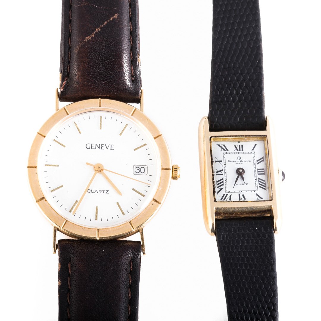 A Lady's Baume and Mercier & Geneve Watch in 14K: 1) 14K yellow gold Baume and Mercier quartz watch, sapphire crown, black leather embossed strap, and 2) 14K yellow gold Geneve watch, quartz, date just, stick numerals, brown leather strap, 42 grams t