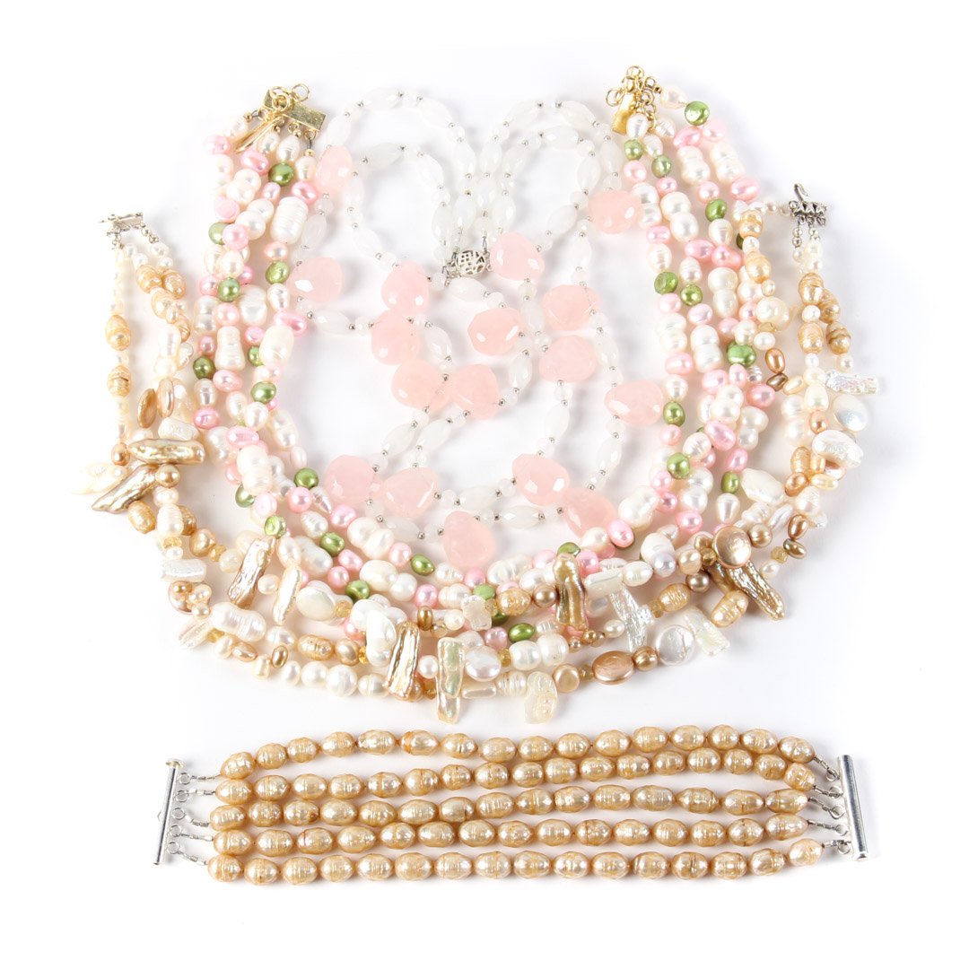 An Assortment of Freshwater Beaded Necklaces: 1) 4-strand white pink and green fresh water pearl necklace on adjustable clasp. and 2) Triple strand champagne and white fresh water pearl necklace, with silver clasp. and 3) 5-strand champagne fresh