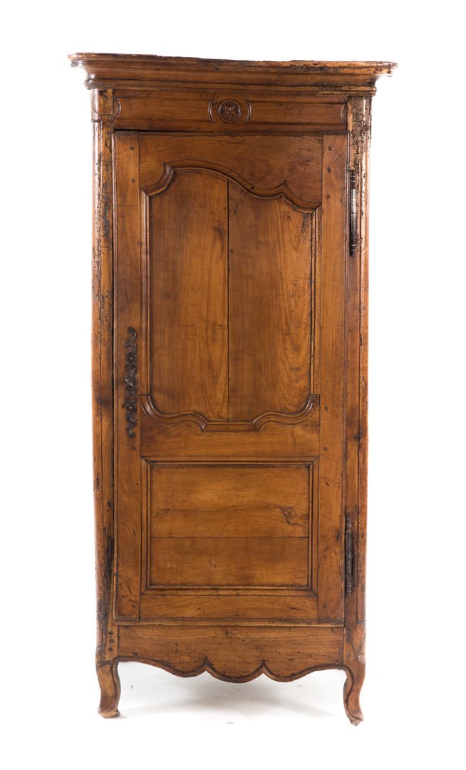 Louis XV country French walnut bonnetiere: 18th century; molded cornice, compartment enclosed by panel-carved door, cabriole legs, 64 7/8 in. H., 31 in. W., 22 1/2 in. D.