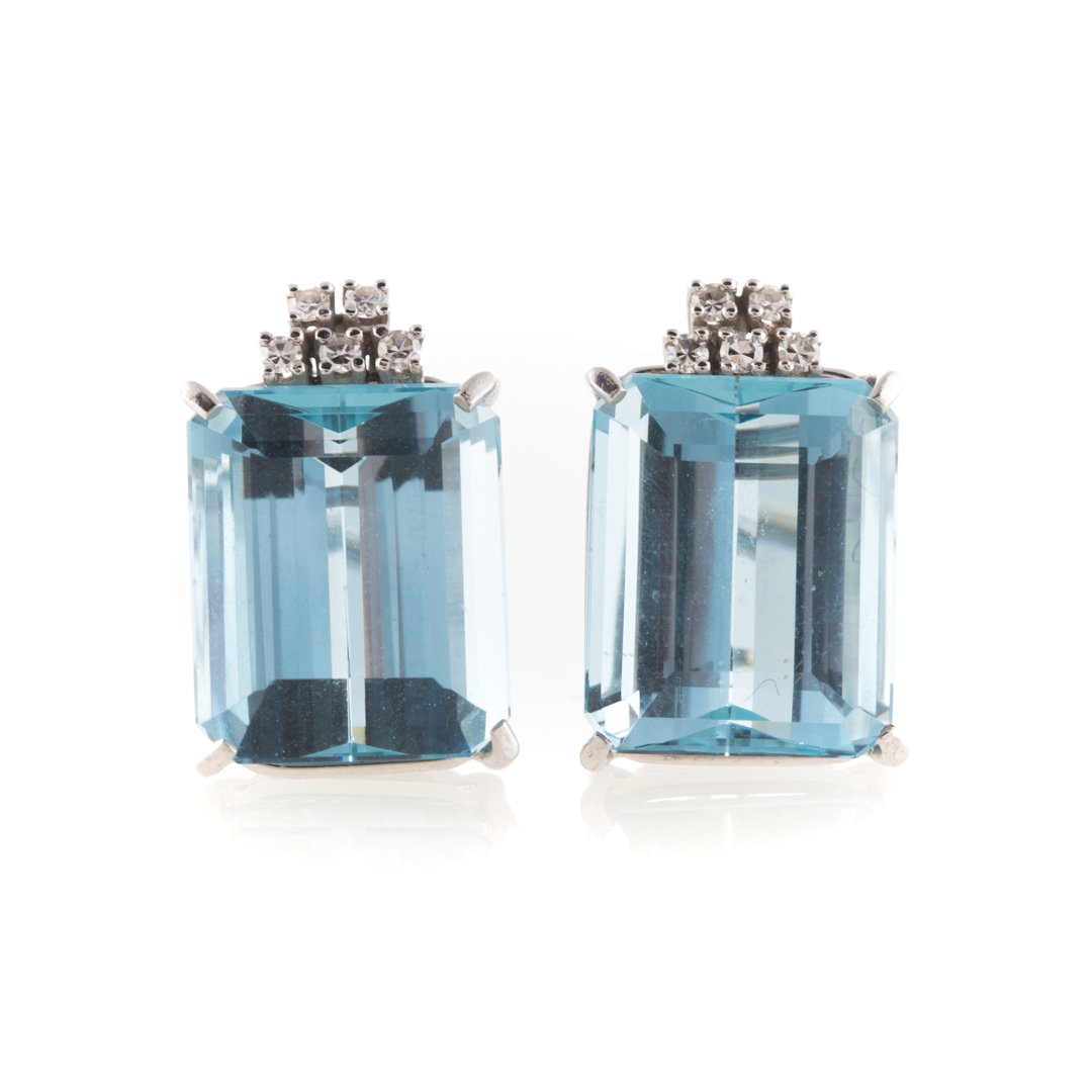 A Pair of Aquamarine and Diamond Earrings: 18K white gold earrings with emerald cut aquamarine measuring 6.2 x 11.5mm with diamond accent, posts with Omega backs, 10 grams