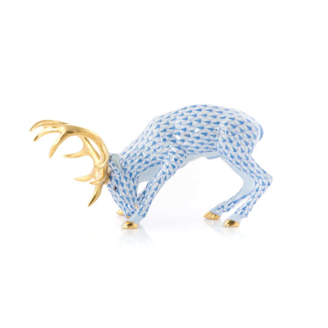Herend porcelain reindeer: blue fishnet pattern, with gilt hooves and antlers, 4 in. H., 6 in. L.