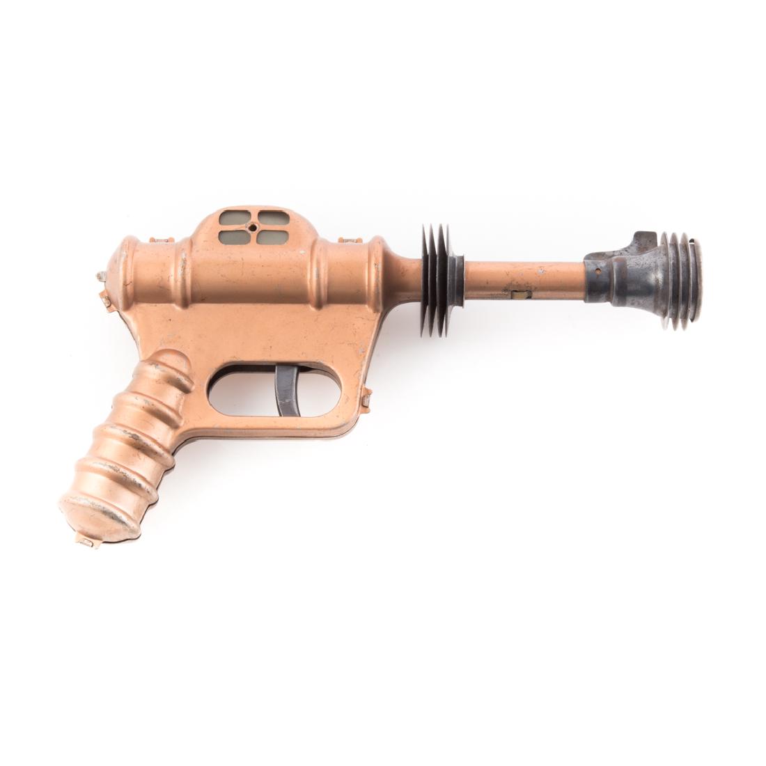 Daisy Buck Rogers U-235 Atomic Pistol: copper colored metal, 9 1/2 in.
