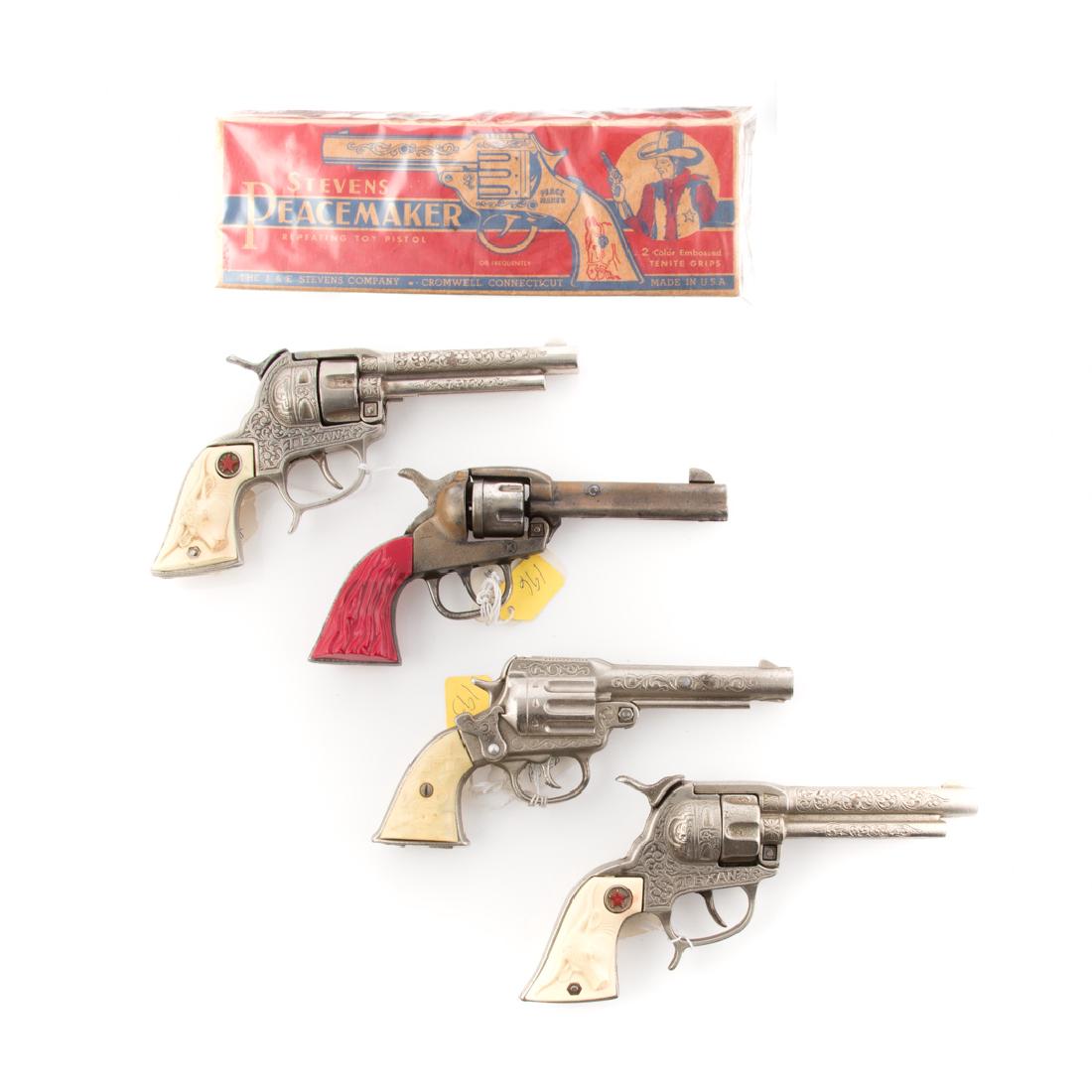 Four Western cap guns: including: Kilgore Big Horn, Stevens Peace Maker, with box and two Hubley Texan, no boxes