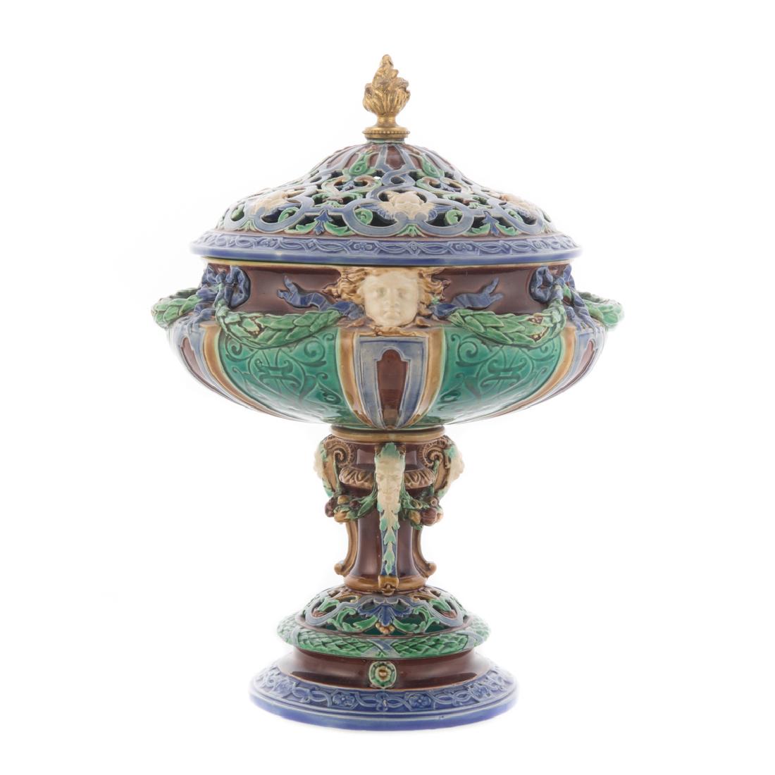 Minton Majolica potpourri urn: fourth quarter-19th century; bowl having satyr masks and floral swag, supported by goat masks and fruit swags with reticulated lid, 10 1/2 in. H.