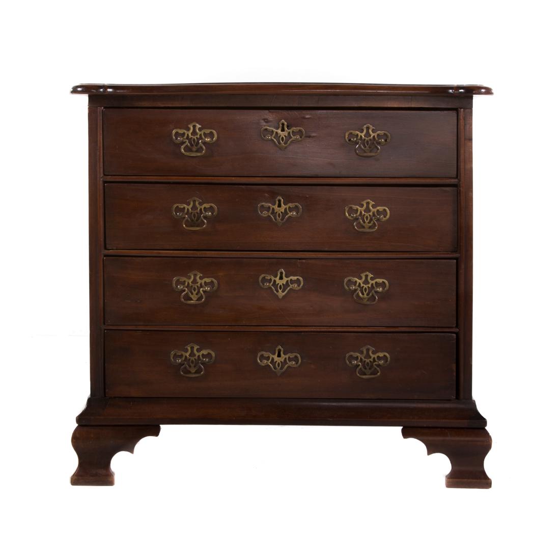 Chippendale style walnut chest of drawers: 19th century; flat top with ovolo corners and molded edge, four long drawers, ogee bracket feet, 32 in. H., 33 in. W., 20 1/2 in. D.