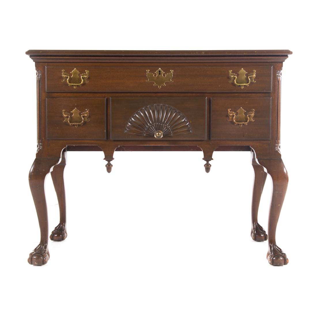 Potthast Chippendale style mahogany lowboy: Potthast Brothers, Baltimore, MD, 20th century; flat top with molded edge, one long drawer, two short and one shell carved drawer in case, fluted quarter column supports, drop finials, cabriole legs,