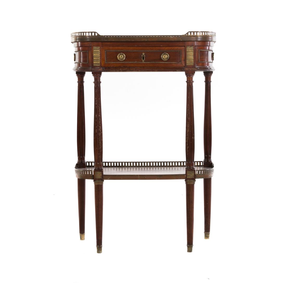 Louis XVI style mahogany side table: 20th century; pierced brass gallery, variegated grey marble top, short drawer in case, four fluted columnar supports connected by shelf stretcher, 34 1/2 in. H., 23 1/2 in. W., 13 1/4 in. D.