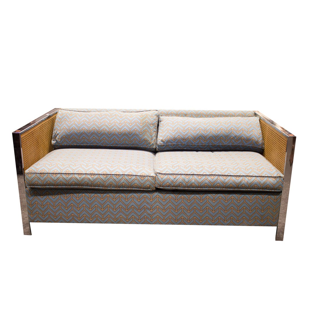 Avery Boardman mid-century style sleeper sofa: 20th century; upholstered back, loose back and seat cushions, chrome and ratan arms, 27 in. H., 66 in. W., 34 in. D.