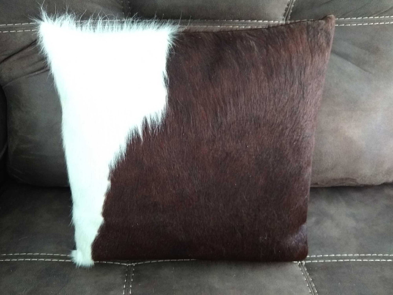 New Brazilian Cowhide Pillows: A pair of New Brazilian "Holstein" Cowhide Pillows. Front is cowhide and back of pillow is cotton blend zip closure. Exceptional craftsmanship. New pillow inserts are included and pillows measure 16'x