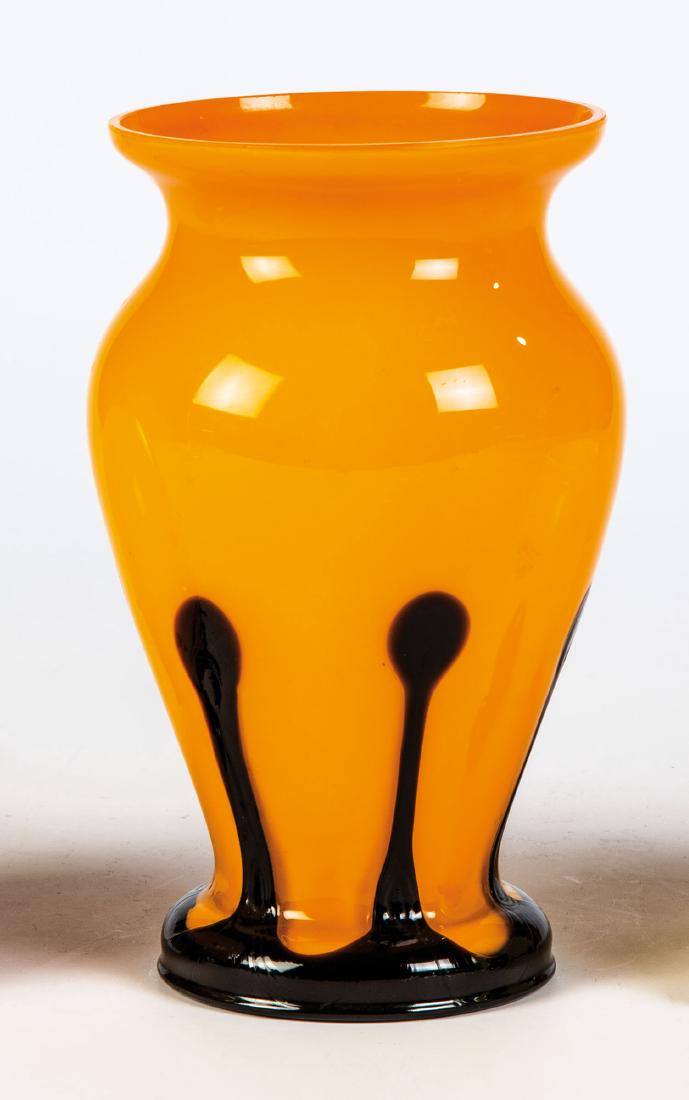 Vase: Vase Loetz Wwe., Klostermühle, um 1920 Opak orangefarbenes, farblos überfangenes Glas. Im unteren Wandungsbereich schwarzvioletter, tropfenförmig nach oben gezogener Teilüberfang. H. 15,7 cm Vase