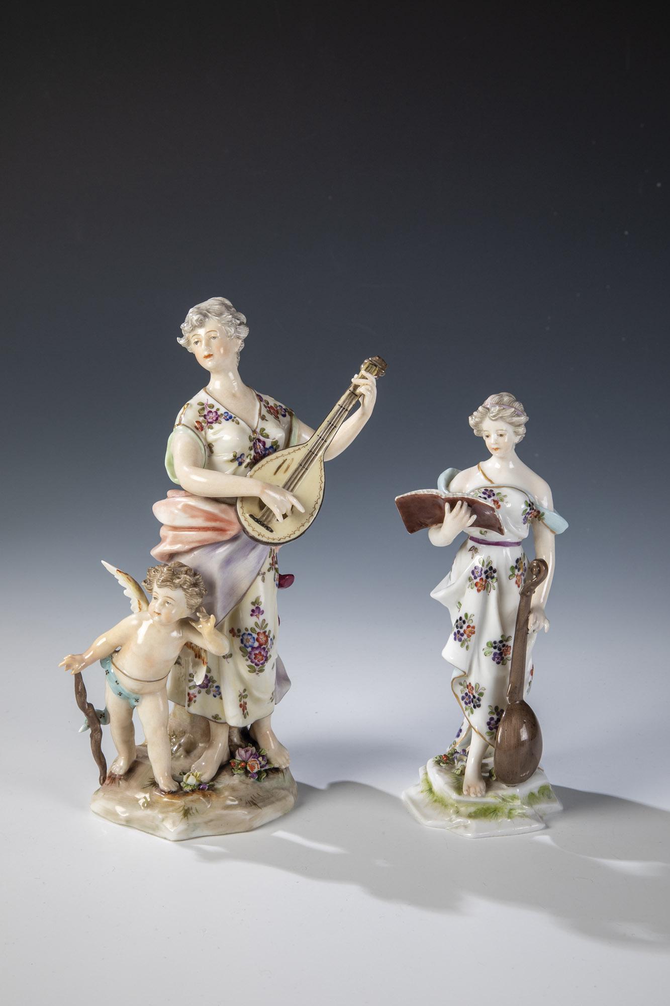 Zwei Musikantinnen: Zwei Musikantinnen Deutsch, Anfang 20. Jahrhundert Auf blÃ¼tenbelegtem Natursockel Lautenspielerinnen mit Amorknabe. Bunt bemalt mit sparsamer Goldstaffage. Rechte Hand des Amorknabens min. rest.. U