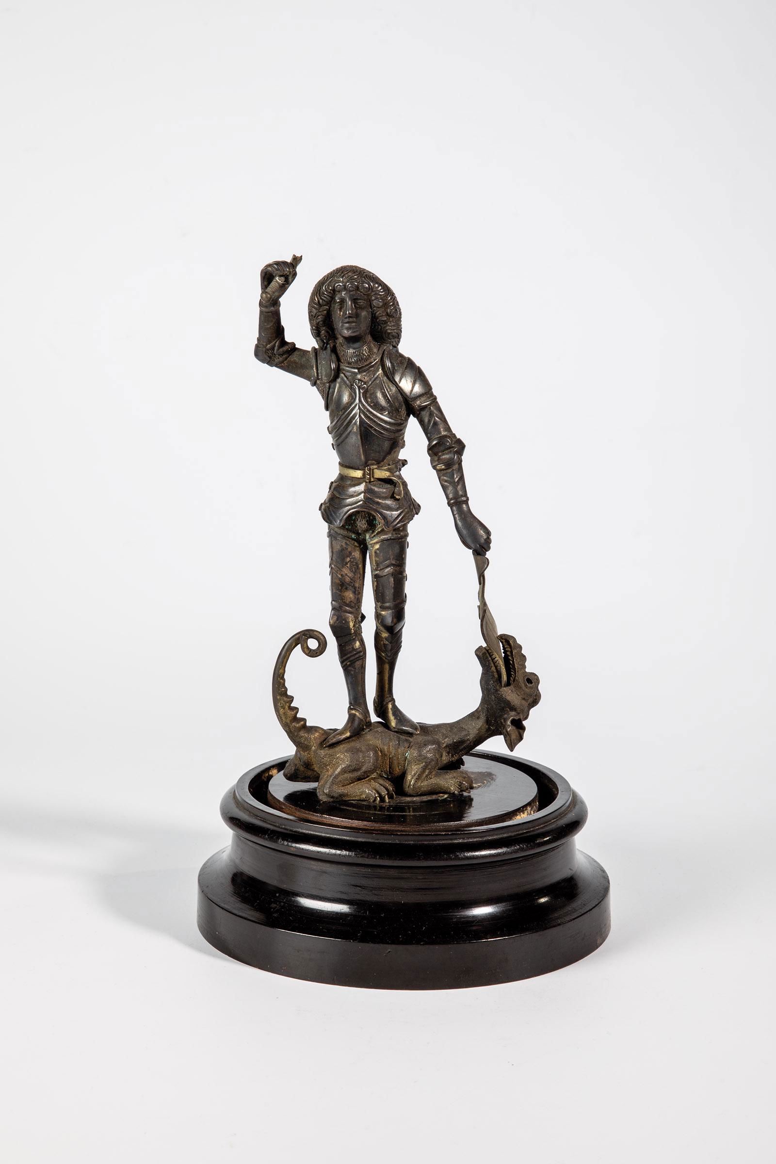 Heiliger Georg: Heiliger Georg Deutsch, um 1890 Heiliger Georg auf dem Drachen stehend mit erhobenem Arm (Schwert fehlt). Metallguß auf Holzsockel montiert, Abrieb. H. 20 cm (ohne Sockel).