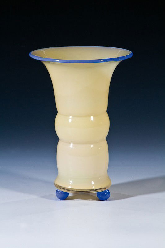 Vase auf Kugelfüßen Loetz Wwe., Klostermühle, um 1: Vase auf Kugelfüßen Loetz Wwe., Klostermühle, um 1915 / 1920 Farbloses Glas mit cremefarbenem Opalunterfang. Um Mündung aufgelegter Faden und drei Kugelfüße aus opakhellblauem Glas. H. 21 cm