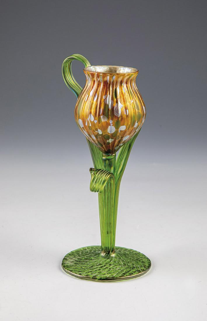 Tulip vase: Tulip vase Loetz Wwe., KlostermÃ¼hle, c. 1903 Longitudinal optically ribbed dome in the shape of a flower calyx made of colorless glass with silver-yellow corolla enamels. Flower stems, applied ribb