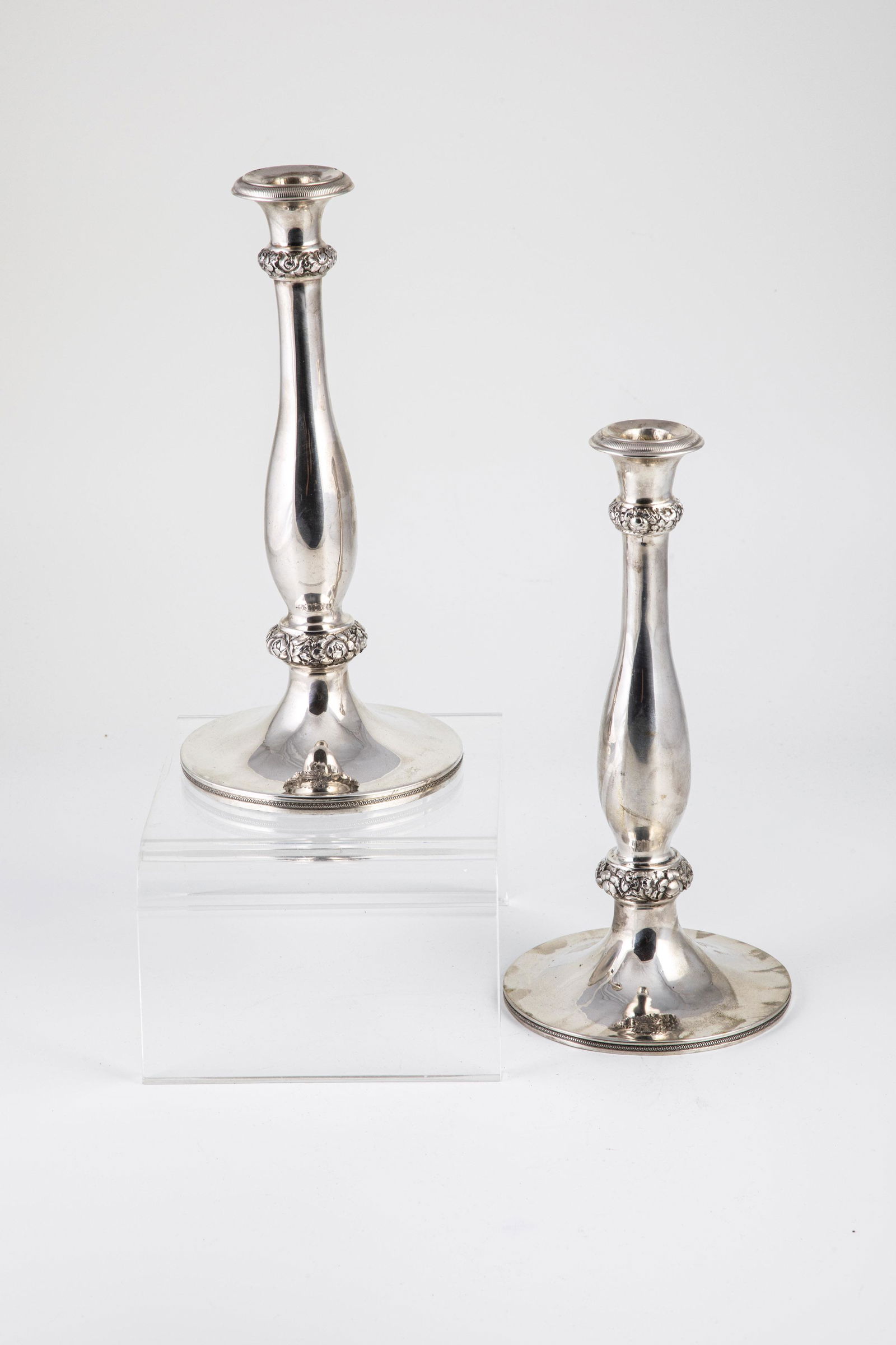 Pair candlesticks: Pair of candlesticks Austria, Vienna, Christian Sander (sen.), 1855 silver. On round base. Single flame. Baluster stem with chased floral decor. Foot with crowned owner's monogram ''A.B.''. Both candl