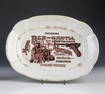 Oval plate with advertising motif of jade and gun store A. Bitkov