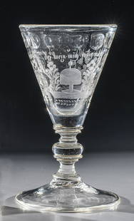 Cup in praise of the wine: Goblet in praise of wine Bohemia, c. 1700 Raised disc base with demolition. Stem consisting of depressed spherical mode between ring discs. On the funnel-shaped dome, fields separated by polished