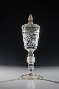 Large screw cup with lid: Large screw-in goblet with lid Bohemia, A. 18th century. On disc base partially deeply cut, partly polished flower branches between leaf borders. The massive, unscrewable shaft is faceted in many