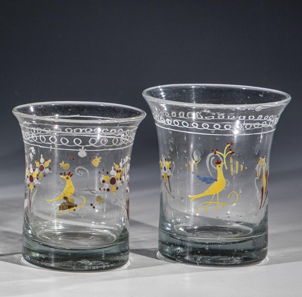 Two cups with depictions of birds: Two cups with depictions of birds France, c. 1800 / 19th c. Sandblasted. Polychrome painted decor: each with a bird surrounded by flowers, reverse ''L''. H. 9,5-10 cm