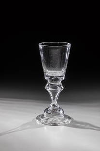 Cup: Pokal Nostetangen, c. 1750 Colorless glass with teardown. Bell base with the edge folded downwards. Hollow baluster shaft. Conically widened cuppa with seven air beads pierced in the bottom. H. 17.5