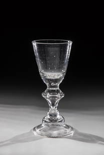 Cup: Pokal Weserbergland 18th century Colorless glass with tear. Bell-shaped base with the edge folded downwards. Hollow baluster shaft. Conically widened cuppa with seven pierced air beads. H. 17.5 cm