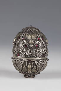 Egg tin with insect dÃ©cor: Egg tin with insect dÃ©cor Russia, stamped Pavel Ovchinnikov silver, partly gilded. Area-filling grape dÃ©cor with insects. Red cabochons, two are missing. Stamped with the stamp of the Moscow