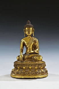 Buddha Shakyamuni: Buddha Shakyamuni Tibet, 18. Jh. Bronze, vergoldet. Auf doppeltem Lotosthron sitzender Buddha in Mönchsgewand die Geste der Erdberührung (bhumiparsa-mudra) ausführend. Sockel geschlossen. H. 14,5 c