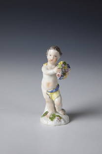 Cherub: Putto Wohl Meissen, ca. 1800 Putto standing on an irregular tree support pedestal, holding a wreath of flowers. Colourfully decorated. On the reverse with an indistinct underglaze blue mark. H. 9 cm.