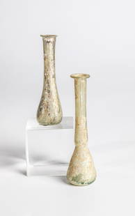 Two vials: Two vials from the Eastern Mediterranean, 2nd-3rd century. Greenish glass. Mouth protruding. H. 9.5-11.2 cm