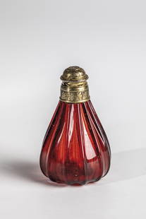 Gold ruby glass bottle with vermeil closure: Gold ruby glass vial with vermeil closure Potsdam or Southern Germany, circa 1700 Teardrop-shaped body with thirteen vertical ribs. Spout with engraved vermeil screw cap. Stickers of the Walter