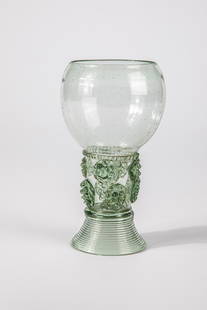 Roemer: Roman German, 17th century Green glass with demolition. Trumpet-shaped, spun foot. Hollow shaft open at the top with two rows of offset applied berry nubs. At the base of the bulbous cuppa, a pinched