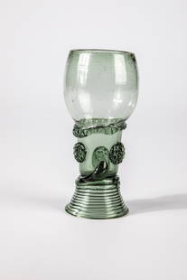 Roemer: Roman German, 17th century Light green glass with spun base, high bottom, on the upper open shaft three applied berry nubs. Pinched thread placed below the cuppa. H. 12 cm Cf. Lit.: Mainfraenkisches M