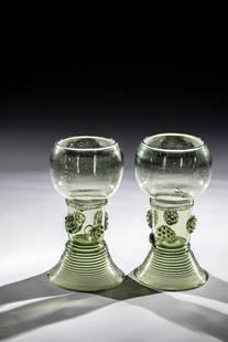 Pair of Roemers: Pair of Romans Germany, 18th century Olive green glass with demolition. Raised, spun foot. On a short, open hollow shaft at the top, four rosette nubs each and circumferential, pinched thread. H. appr