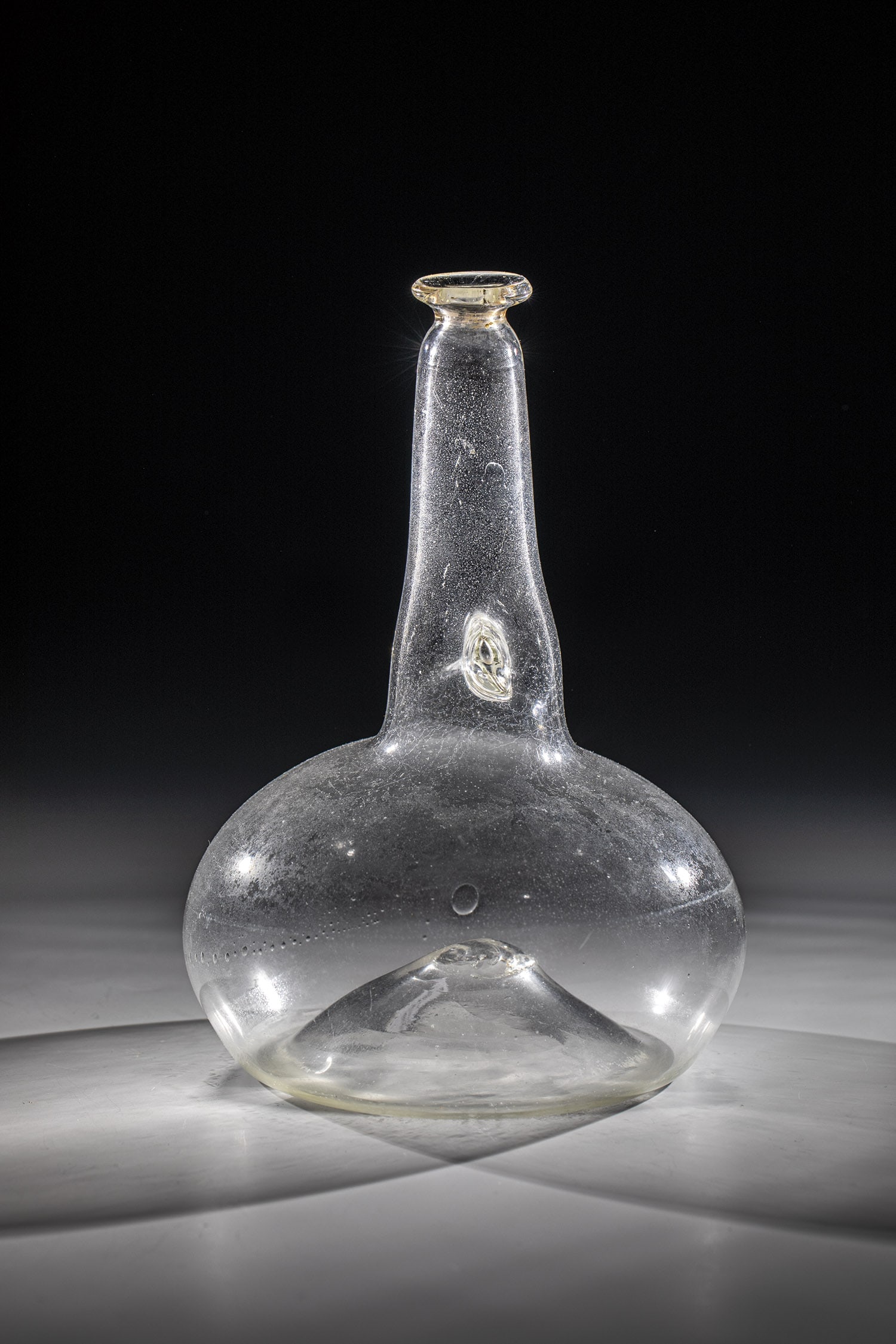 Shepherd's Bottle: Shepherd's bottle Italy, 1st half of the 19th century so-called ''Bozza''. Colorless glass. Pressed spherical shape with a raised bottom and tear-off, the high tubular neck pressed in one place on bot