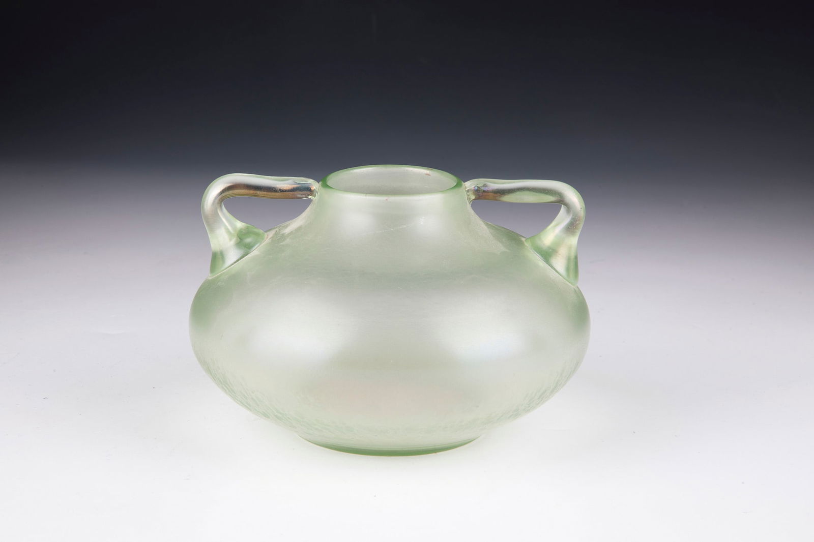 Decorative Handle Vase ''Olympia Smooth'': Ornamental Handle Vase ''Olympia Glatt'' Loetz Wwe., Klostermühle, 1899 Light green, optically blown glass. Two attached handle appliqués on the sides. Matt iridescent. H. 8.5 cm.