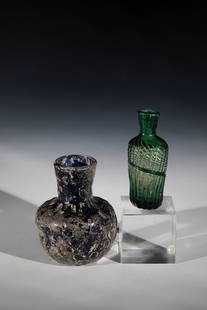 Two vials: Two vials 2nd/3rd century and 15th century Green or blue glass with tear-off. Cross rib or coat of arms decoration. Short jump. H. 9.4-9.8 cm