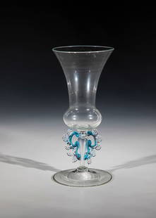 Wing glass: Casement glass Netherlands, Façon de Venise 1st half of the 17th century. Slightly rising disc foot. Hollow baluster shaft with light blue appliqués to which pinched, colourless wings are applied.