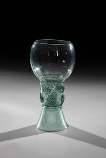 Roman: Roman German, 17th century Green glass with tear-off. Spun foot glued. On the shaft, which is open at the top, there are two rows of staggered appliquéd berry nubs. Below the longitudinally
