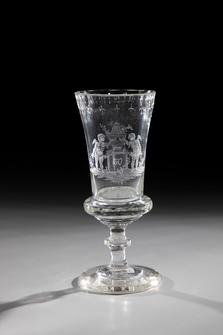 Jubilee Cup: Jubilee Cup North Bohemia around 1830 disc base with polished demolition. Edge, nodus, cuppa base and lip rim peeled. On the slender, slightly widened cuppa, cut partly bleached decoration: two angels