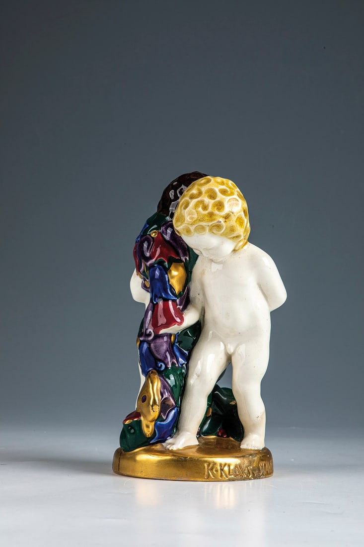 Pair of cherubs with flower garland and butterfly (#58): Pair of cherubs with flower garland and butterfly Karl Klaus and Franz Staudigl (design), Ernst On a gilded round base. Decorated in polychrome underglaze painting. Embossed on the edge of the base in