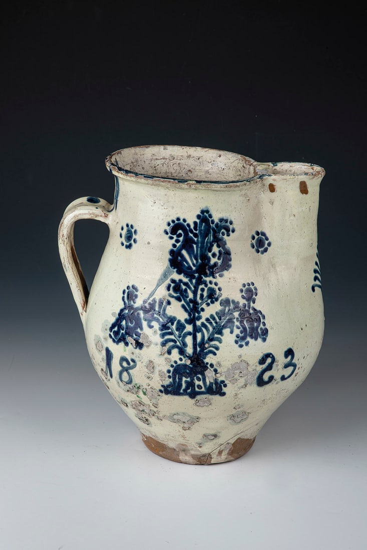Transylvanian Wine Jug: Wine jug Transylvania, probably Draas, dated 1823 On the belly wall with cloverleaf spout painted decoration in blue: Tree of life with tulip and rosette blossoms. The décor dates ''1823''. Ribbon ha