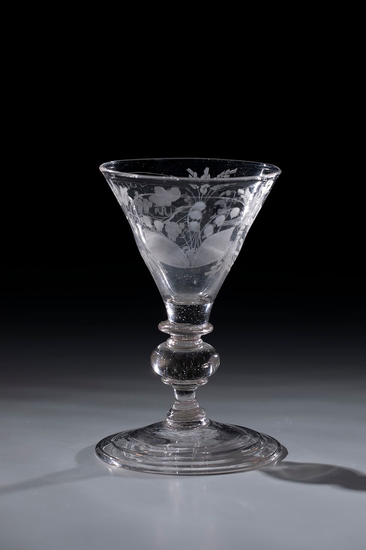 Goblet: Pointed chalice Bohemia, 18th century, disc base with tear and folded edge downwards. Pressed ball nodus between two ring discs. On the funnel-shaped cuppa, three engraved round medallions with bird,