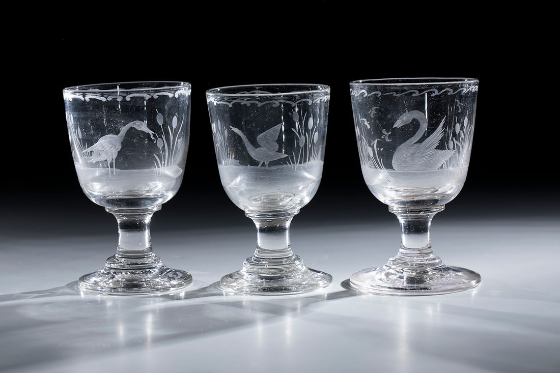 Three Foot Mugs with Birds: Three foot cups with birds, 19th century, disc base with tear-off. Depiction of swan, goose and stork cut on the bulbous cuppa. Below the lip edge slide-in décor. H. 11 cm