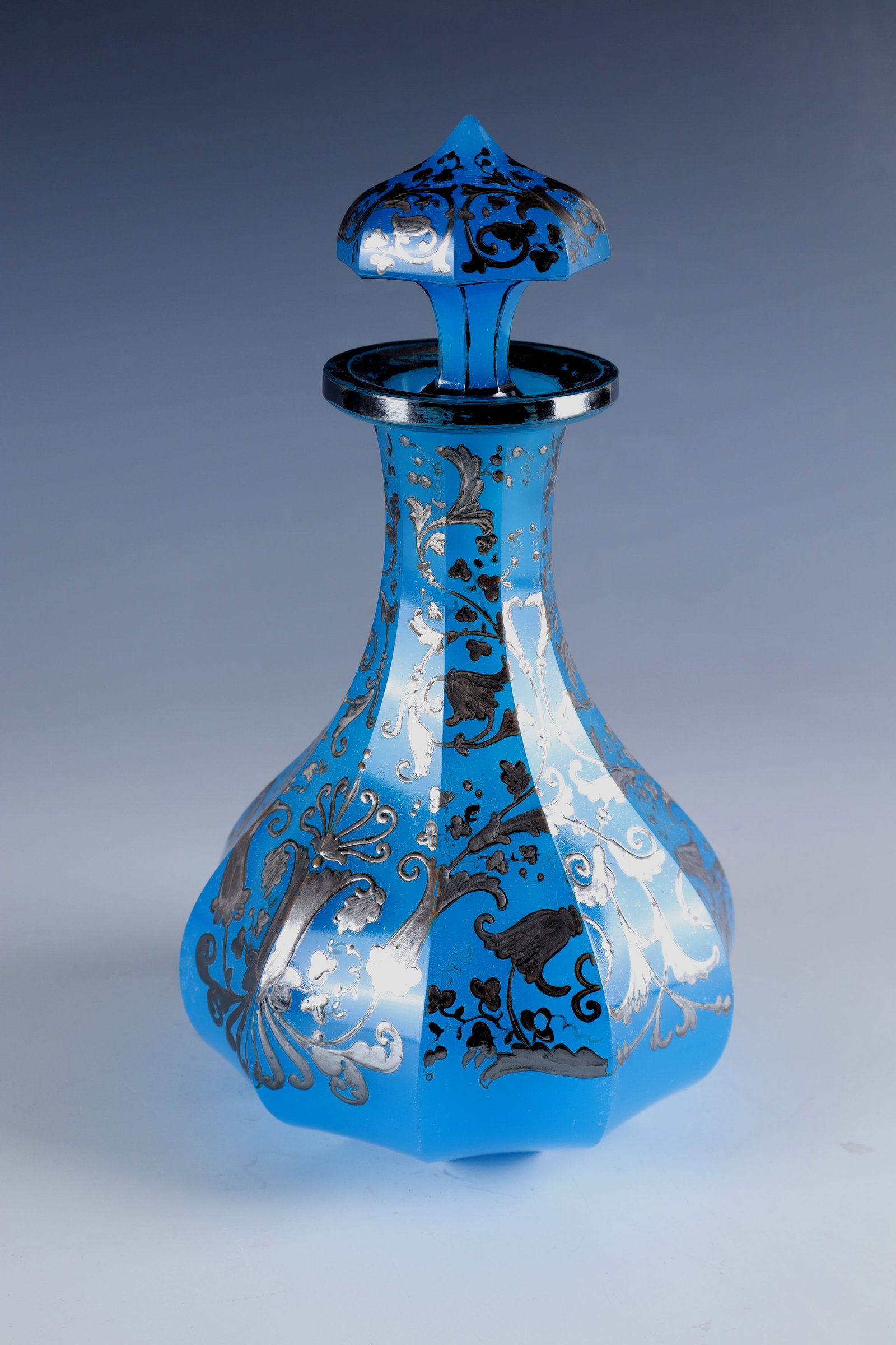 Carafe with stopper: Carafe with stopper North Bohemia, c. 1840 Blue alabaster glass. Slightly hollow sanded bottom. The bulbous wall is faceted in many ways and decorated with silver painting: stylized flowers, leaves an