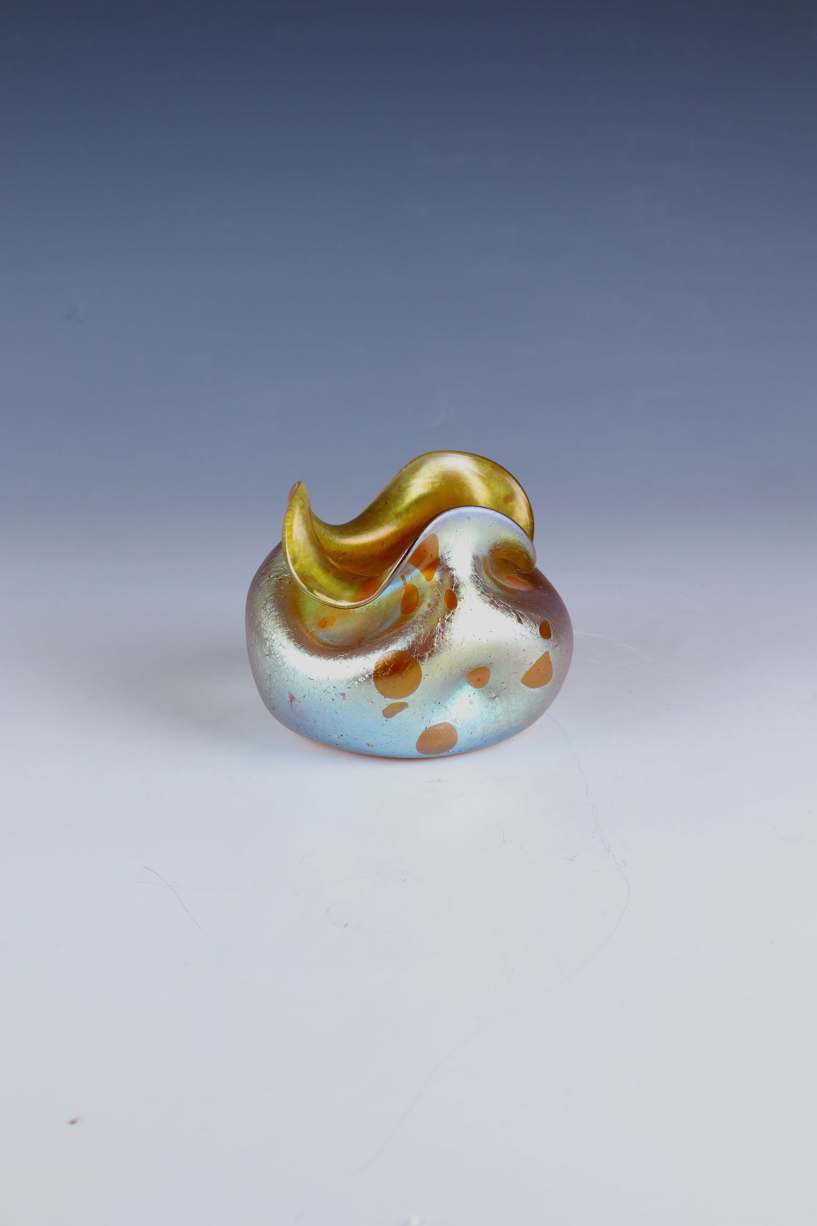 Small Vase ''Asträa'': Small vase ''Asträa'' Loetz Wwe., Klostermühle, c. 1900 Colourless glass with silver-yellow powder melting and scattered dots in silver-yellow. Triple dented and correspondingly lobed muzzle rim. Ma