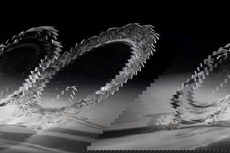 Two plates: Two plates of Lalique, Wingen-sur-Moder, 20th century Colourless glass, pressed into the mould, partially finished by polishing. Relief decoration on the flags: frieze with fish or leaves. Underside