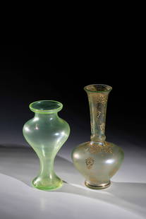 Two vases: Two vases Loetz Wwe., Klostermühle, 1910 Light green uranium glass. A vase with all-round decoration in relief and polished gold painting: stylized foliage. Iridescent. H. 18.5 or 22.5 cm.Zwei