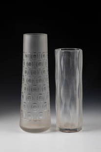 Two vases: Two vases Hanns Model, second half of the 20th century Colourless glass with serrated edge and with rough-matt and partly polished carved structures. A vibro-engraved vase monogrammed ''HM''. H. 21